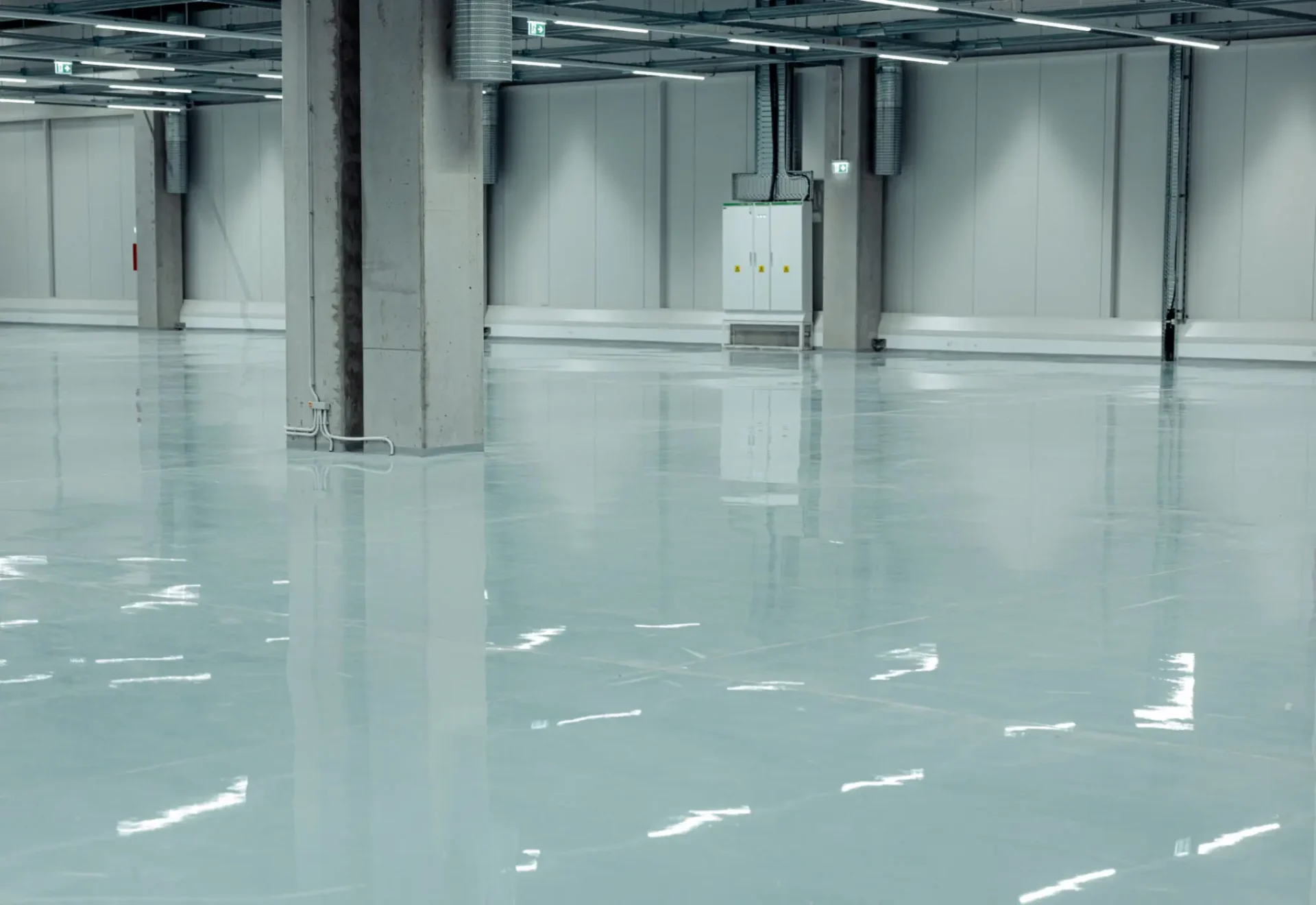 Empty warehouse with polished concrete floor.