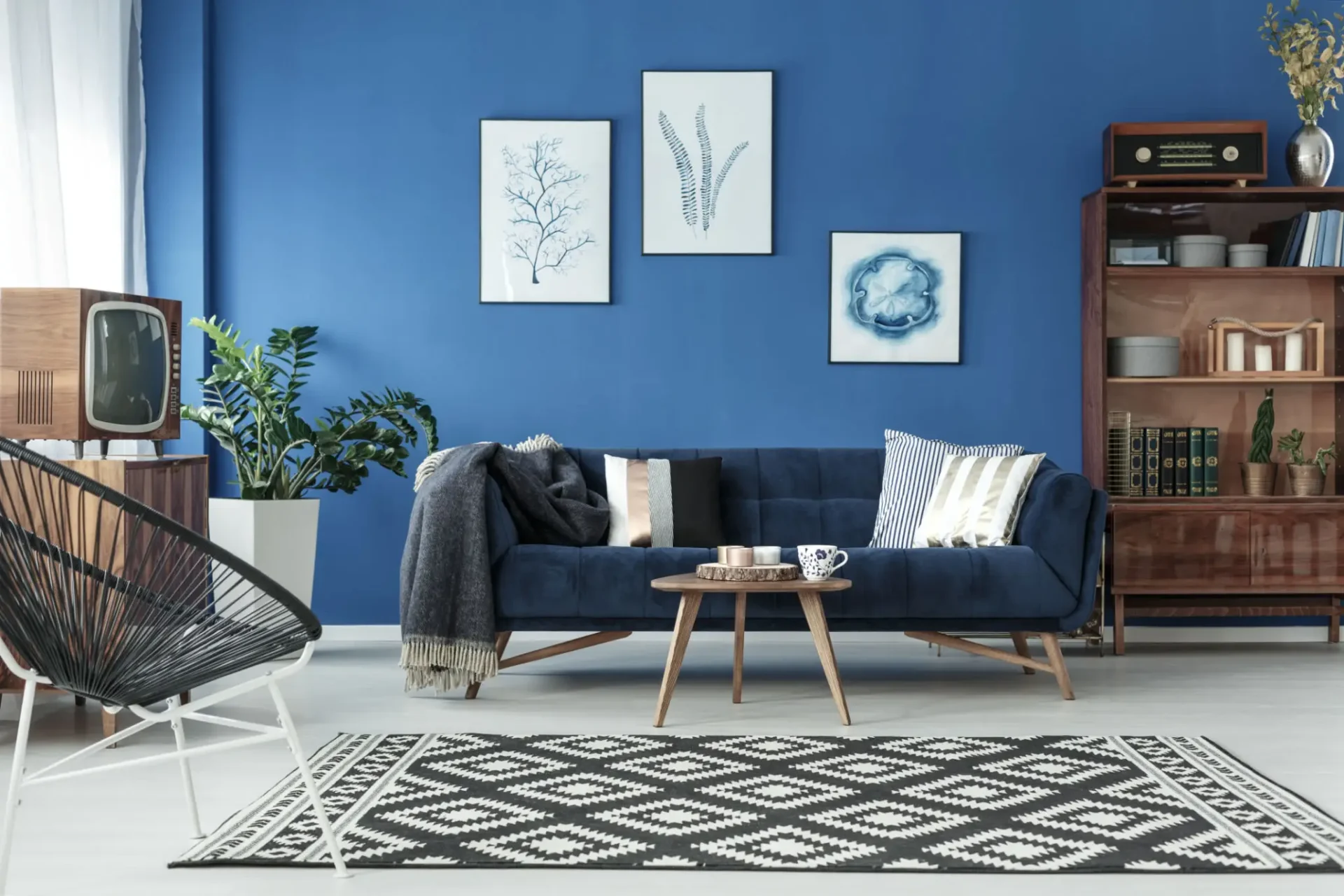 Mid-century modern living room with blue sofa.