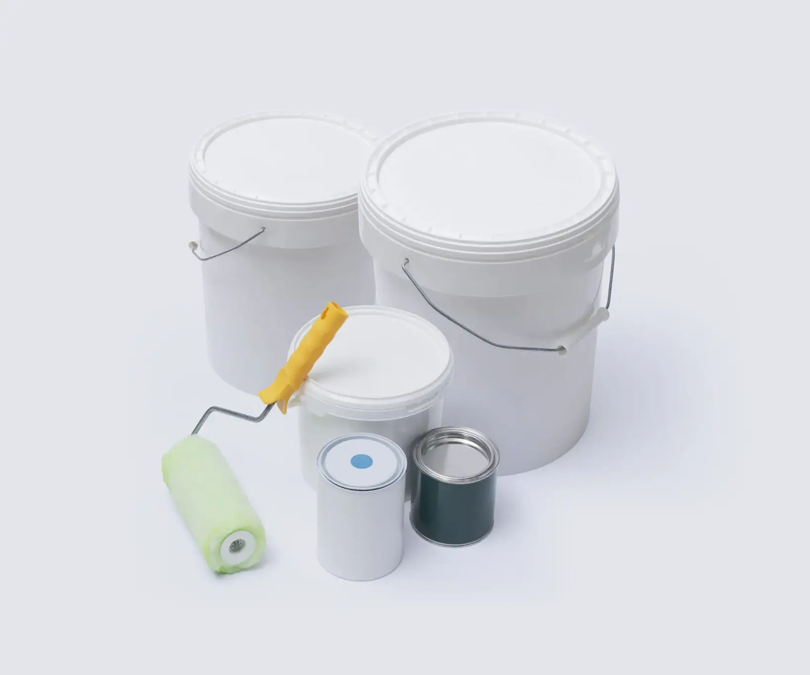 Paint buckets and rollers on white background.