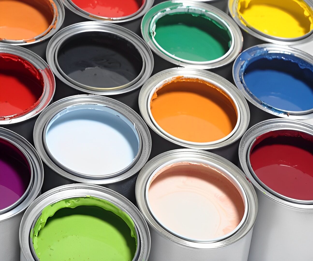 Open paint cans in various vibrant colors.