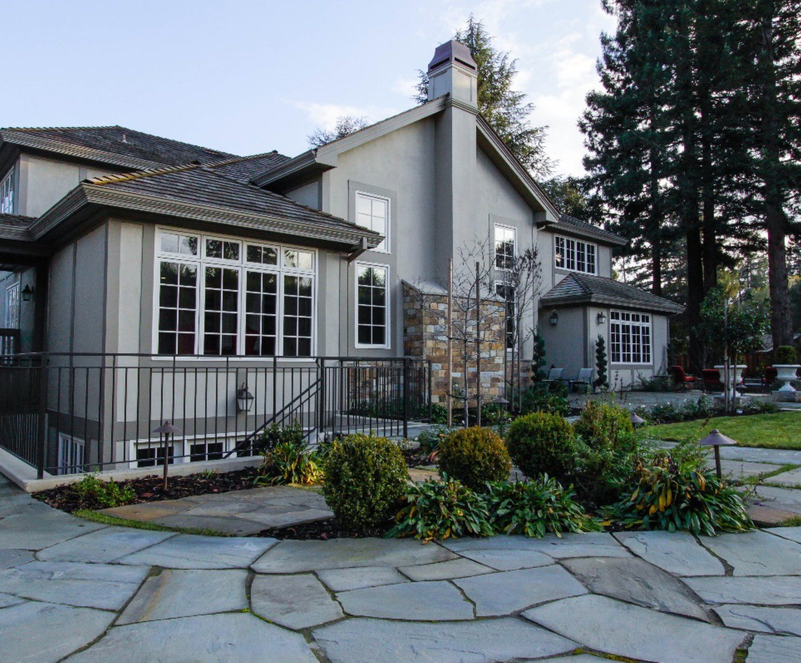 Large house with landscaped garden and patio.