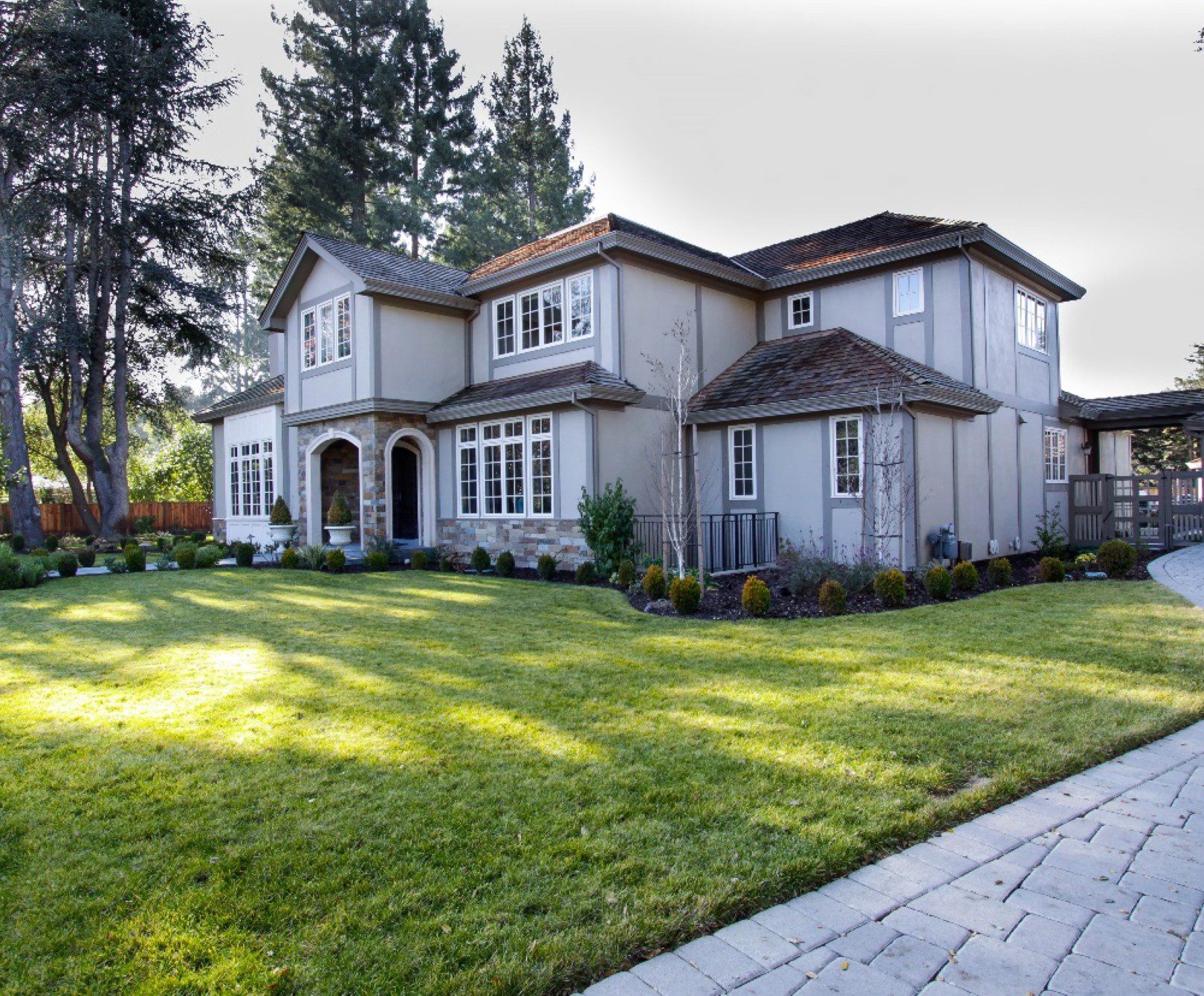 Large house with garden and paved pathway.