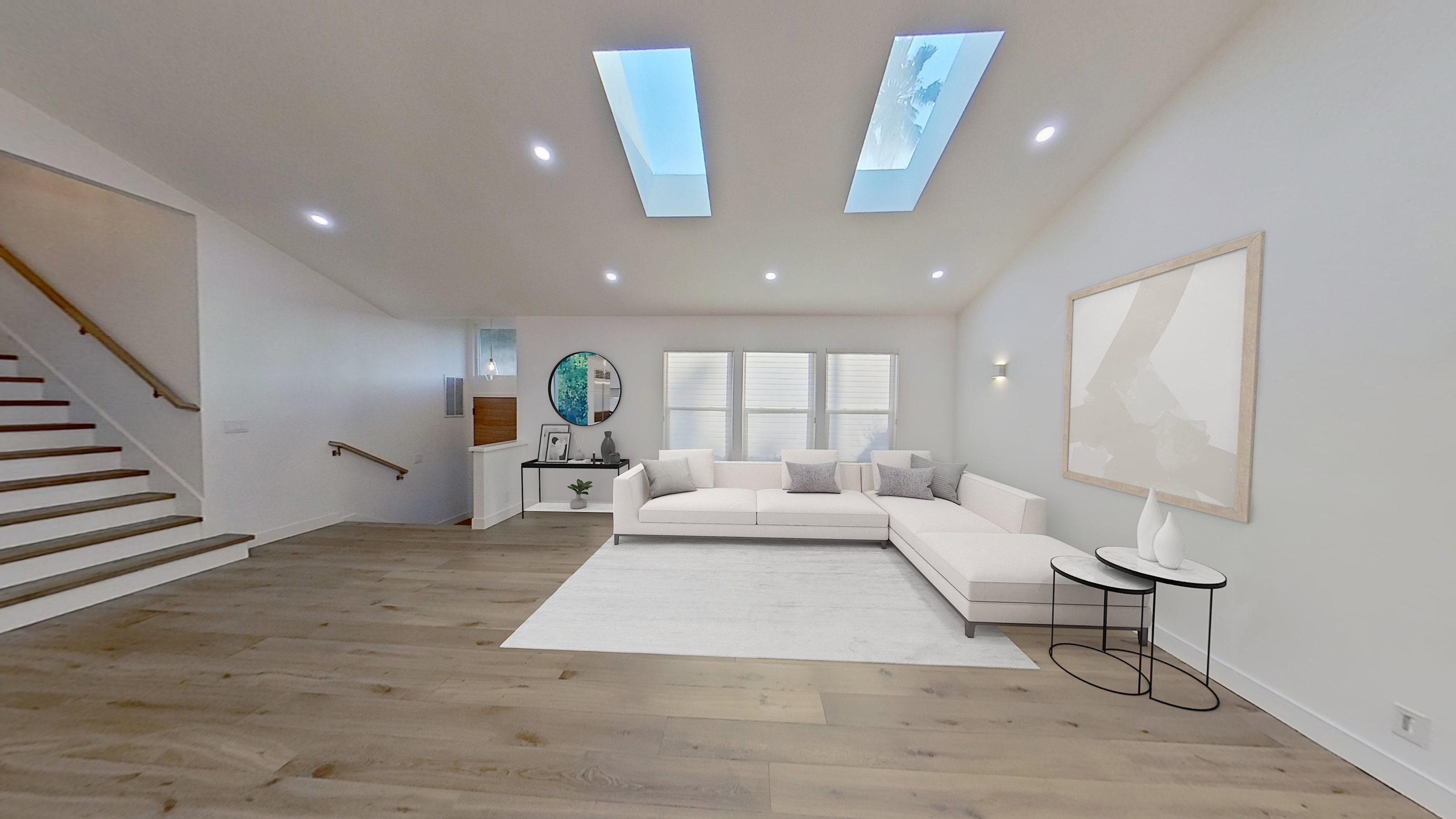 Bright modern living room with white sectional sofa and skylights.