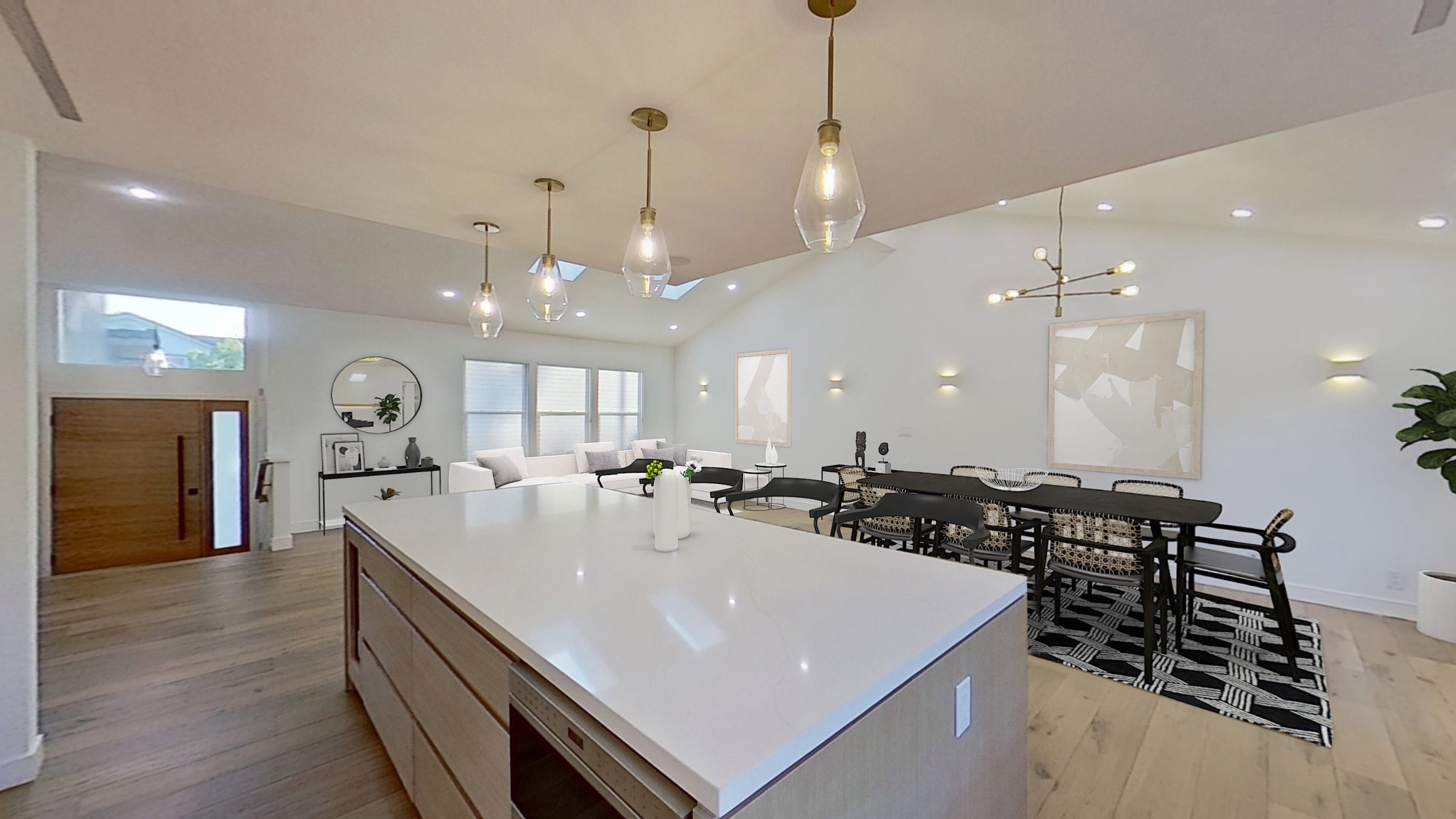 Modern kitchen with a large white island and pendant lighting.